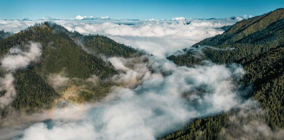 Snow caped mountain filled with beautiful clouds in Bhutan